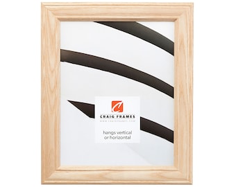 May include: A natural wood picture frame with a simple design. The frame is light brown and has a smooth finish. It hangs vertically or horizontally. Craig Frames www.craigframes.com