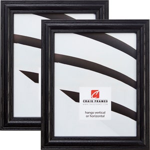 May include: Two black wood picture frames with a white mat and a white background. The frames are 8x10 inches and can be hung vertically or horizontally. The frames are made by Craig Frames.