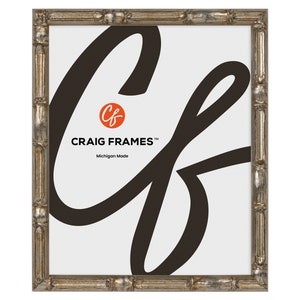 May include: A silver picture frame with a decorative, ornate design. The frame is made of wood and has a distressed finish. The frame is 8x10 inches.