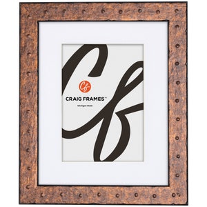 May include: A copper-toned picture frame with a textured, hammered finish. The frame has a white mat and a black inner edge. The frame features the text "CRAIG FRAMES™ Michigan Made".