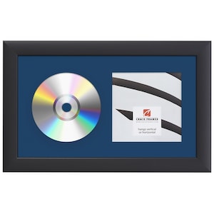 May include: Black frame with a navy blue mount and a silver CD in the left side of the mount. The right side of the mount has a white card with black stripes and the text "Craig Frames" in red. The text "hangs vertical or horizontal" is also on the card.