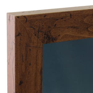 May include: A dark brown wooden picture frame with a dark blue mat. The frame has a rustic, distressed look.