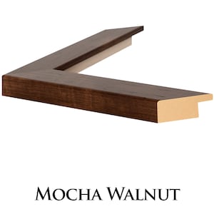 May include: Close-up of a dark brown wood picture frame with a slightly raised edge. The frame has a smooth finish and a subtle wood grain pattern. The frame is labelled "MOCHA WALNUT".