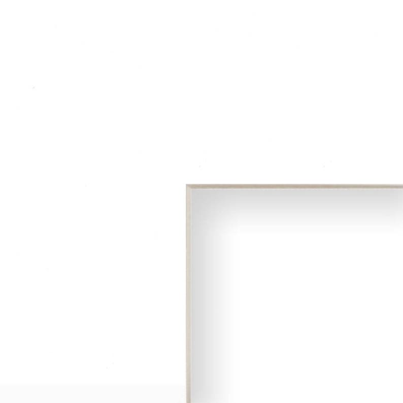 May include: A rectangular mirror with a light beige frame. The mirror's surface is white, reflecting light. The design is simple and minimalist.