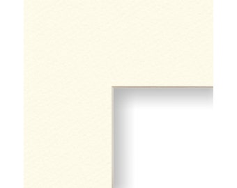 May include: A white mat board with a cut-out opening for a picture or artwork. The mat board is a standard size for framing.