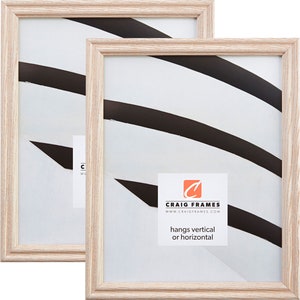 May include: Set of two natural wood picture frames with a white mat. The frames are 8x10 inches and can be hung vertically or horizontally. The frames are made by Craig Frames.
