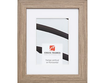 May include: A light wood picture frame with a white mat and a white background. The frame is 8x10 inches and hangs vertically or horizontally. The frame has a simple design and is perfect for displaying photos or artwork.