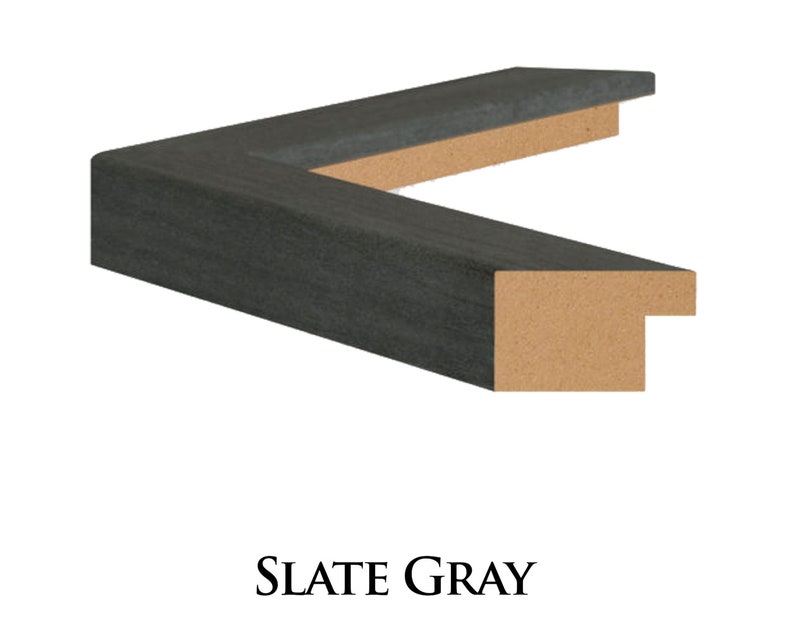 May include: A close-up of a dark grey picture frame with a wood core. The frame is made of a textured material that resembles slate.