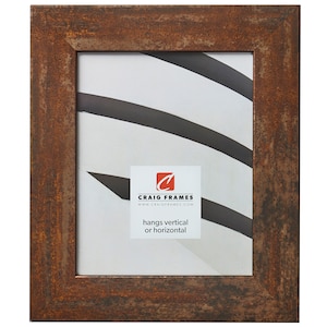 May include: A rectangular picture frame with a distressed, rusty brown finish. The frame has a simple, classic design and a white interior. The frame includes the text "Craig Frames" and "hangs vertical or horizontal".