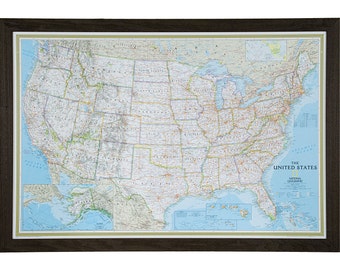 May include: A framed map of the United States with a blue background and yellow borders. The map includes Alaska and Hawaii. The title of the map is "The United States" with the National Geographic logo below.