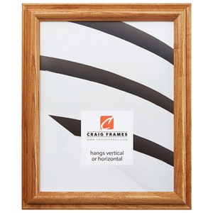 May include: A rectangular wooden picture frame with a light brown finish. The frame has a simple, classic design and a white interior with black and white abstract shapes. The frame includes the text "Craig Frames" and "hangs vertical or horizontal".