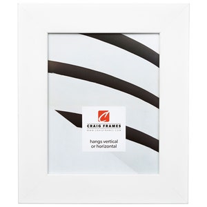 May include: White picture frame with a simple, clean design. The frame is made of wood and has a white mat. The frame is 11x14 inches and can be hung vertically or horizontally. The frame is made by Craig Frames.