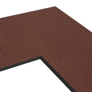 May include: Close-up of a brown football-patterned surface with a black border.