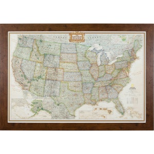 May include: A framed map of the United States with a detailed view of each state. The map is in a brown wooden frame and features the National Geographic logo. The map includes Alaska and Hawaii.