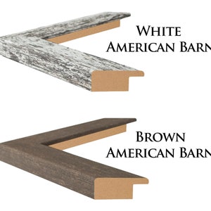 May include: Two wooden picture frames with a distressed finish. The top frame is white and the bottom frame is brown. Both frames have the text "AMERICAN BARN" printed on them.