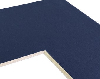 May include: A close-up of the corner of a dark blue mount board. The mount board has a white core.