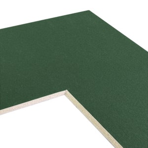 May include: A close-up of a green mat board with a white core. The mat board is textured and has a slight sheen.