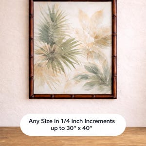 May include: A framed botanical print with watercolour illustrations of palm leaves and tropical foliage in green, beige, and brown. The dark brown frame has a bamboo style. Text on the image reads: Any Size in 1/4 inch Increments up to 30" x 40".