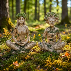 May include: Two serene statues of figures in a meditative pose, crafted to resemble trees. The statues are in a forest setting, with intricate details of bark, moss, and leafy crowns. The figures are seated cross-legged, with closed eyes.