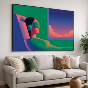 May include: A large framed art print showing a person wearing VR glasses, reclining in a chair. The artwork uses a vibrant colour palette of green, blue, and pink, with a window showing a sunset. The print is displayed above a beige sofa.