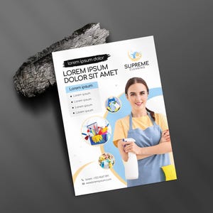 May include: A flyer for Supreme Cleaning features a woman in a yellow shirt and blue apron holding a spray bottle. The flyer includes the text "Lorem ipsum dolor" and "LOREM IPSUM DOLOR SIT AMET". Additional text includes "Lorem ipsum" and a phone number.