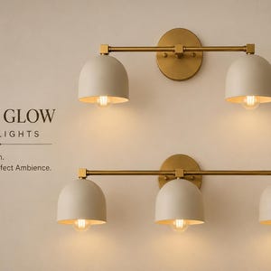 May include: Two wall light fixtures with brass hardware and matte off-white dome shades. The top fixture has two lights, and the bottom has three. Text reads: DOME GLOW WALL LIGHTS. Timeless Design. Warm Glow. Perfect Ambience.