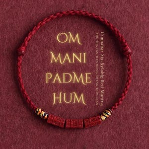 May include: A red braided bracelet with the mantra "Om Mani Padme Hum" and the text "Cimnabar Six-Syllable Red Mantra" in gold lettering. The bracelet features small, rectangular red beads with carved symbols.