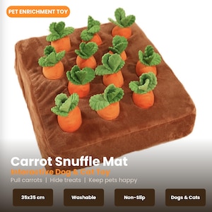 Könnte beinhalten: Ein brauner Plüschteppich mit orangefarbenen Karotten-Spielzeugen und grünen Blattoberteilen. Der Teppich misst 35x35 cm und trägt die Aufschrift "Carrot Snuffle Mat" und "Interactive Dog & Cat Toy". Waschbar und rutschfest.