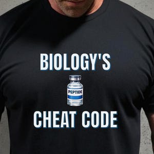 May include: Black t-shirt with the text "BIOLOGY'S CHEAT CODE" in white and blue. A small vial labeled "PEPTIDE" is centered between the text. The shirt is a crew neck and appears to be made of a soft material.