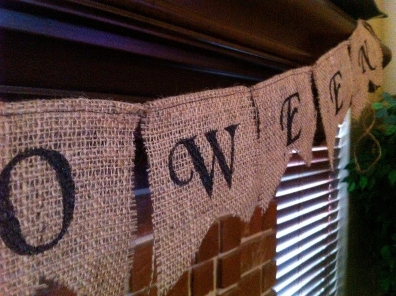 This is a burlap banner that says halloween. The burlap is a natural color with hand painted letters in black. The font is super fun with fun accents on each letter.