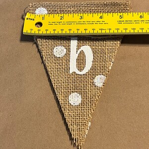 This photo shows that each triangular flag in the banner is approximately 5.5 inches wide at the top.