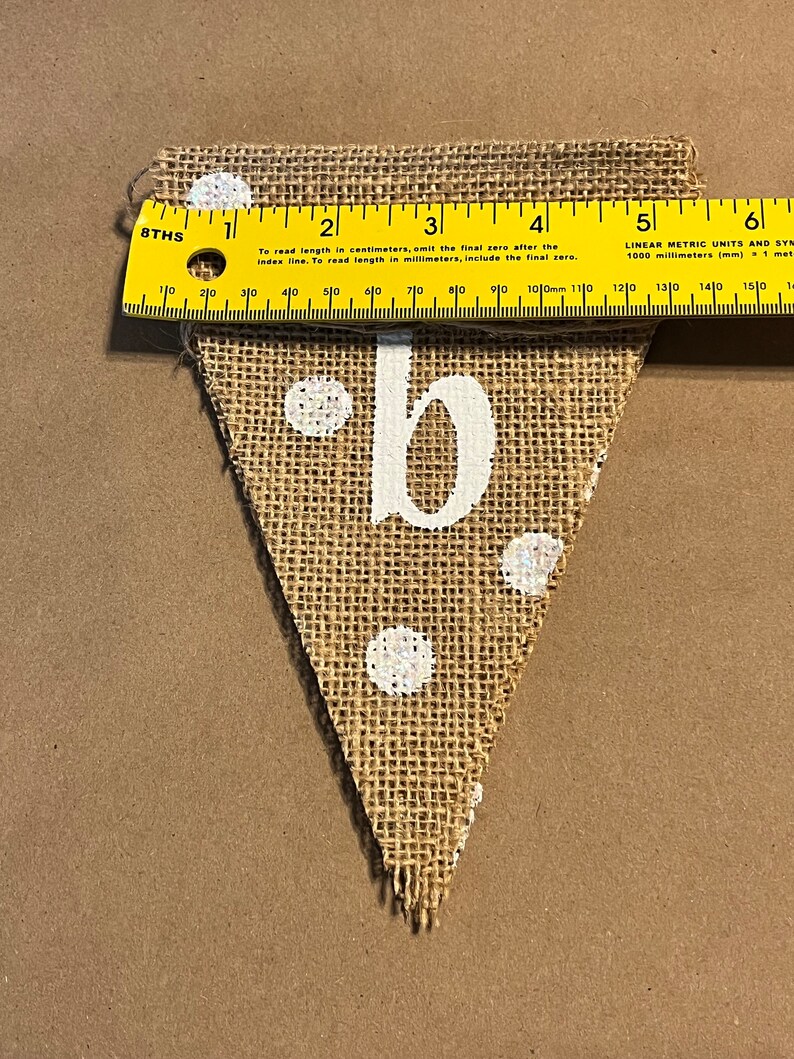 This photo shows that each triangular flag in the banner is approximately 5.5 inches wide at the top.