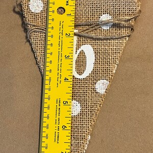 This photo shows that each triangular flag in the banner is approximately 7.5 inches tall.