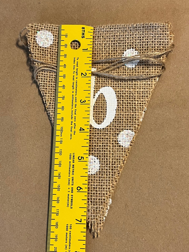 This photo shows that each triangular flag in the banner is approximately 7.5 inches tall.