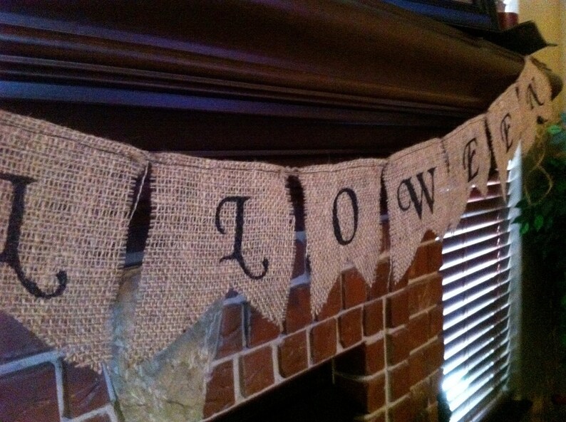This is a burlap banner that says halloween. The burlap is a natural color with hand painted letters in black. The font is super fun with fun accents on each letter.