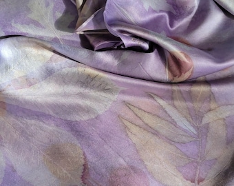 May include: A purple silk scarf with a leaf pattern in shades of brown and white.