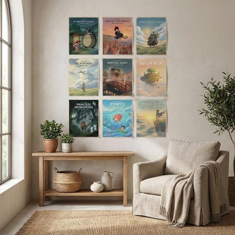 May include: A collection of nine rectangular movie posters arranged in a grid on a wall. The posters feature colorful animated scenes with titles including My Neighbor Totoro, Kiki's Delivery Service, Howl's Moving Castle, The Wind Rises, Spirited Away, Castle in the Sky, Princess Mononoke, Ponyo, and Nausica&auml; of the Valley of the Wind.