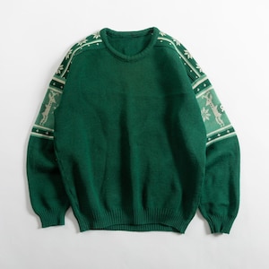 May include: A green sweater with a crew neck and long sleeves. The sleeves feature a pattern of reindeer and snowflakes in white and light green. The sweater is made of a knitted material.
