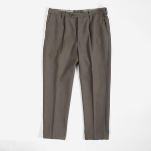 May include: Taupe-colored trousers featuring a high-waisted design with a single button closure, a metal hook-and-eye fastener, belt loops, and two side pockets. The pants have a straight-leg cut with a pressed crease running down each leg.