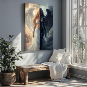 May include: A rectangular wall art print featuring a split-figure composition. One side depicts a light-skinned figure with long blonde hair and large white wings against a bright sky. The other side shows a dark-skinned figure with black wings.