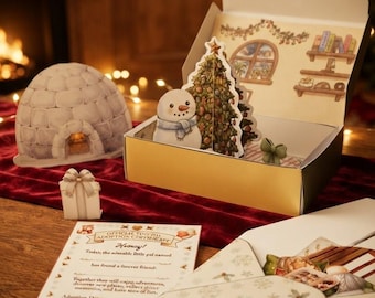 Könnte beinhalten: Ein weihnachtliches Geschenkset mit einem aufklappbaren Schneemann und Weihnachtsbaum, einem separaten Iglu-Ausschnitt, einer kleinen Geschenkbox und einer offiziellen Adoptionsurkunde mit dem Text "Official Toy Pal Adoption Certificate."