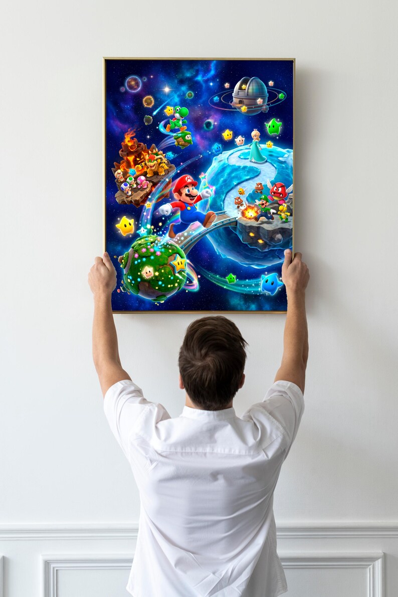May include: A rectangular framed wall art print featuring a vibrant space scene with Mario, Luigi, Princess Rosalina, Bowser, and Yoshi navigating various planets and floating islands against a deep blue cosmic background filled with stars.