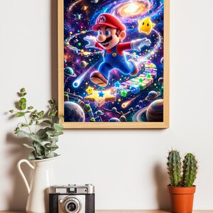 May include: A framed print featuring Mario from the Super Mario Bros. video game series. Mario is depicted mid-jump in a colorful space scene with stars and planets. The artwork is in a wooden frame and is displayed on a wooden surface.