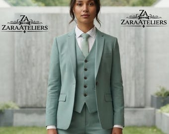 May include: A sage green three-piece suit featuring a single-breasted blazer, a matching vest with five dark buttons, and a light-colored dress shirt with a sage green necktie. The ZaraAteliers logo is visible on both sides of the image.