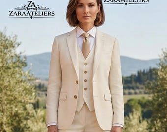 May include: A beige three-piece suit consisting of a blazer, a button-up vest, and trousers, worn with a white collared shirt and a beige tie. The text ZARAATELIERS is visible in the upper corners of the image. The suit features a classic cut.