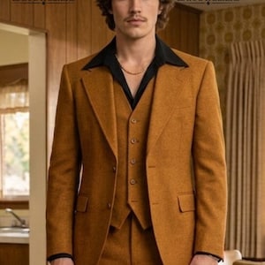 May include: A three-piece mustard-colored suit with a black collared shirt underneath. The suit includes a blazer, vest, and trousers. The image features the ZaraAteliers logo in the top left and right corners.
