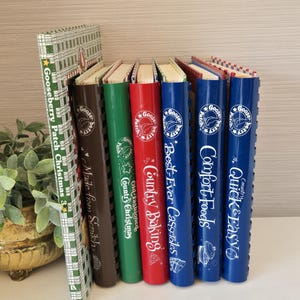 May include: A collection of six spiral-bound Gooseberry Patch cookbooks standing upright. The titles include Gooseberry Patch Christmas, Made from Scratch, Old-Fashioned Country Christmas, Country Baking, Best-Ever Casseroles, Comfort Foods, and Quick & Easy.
