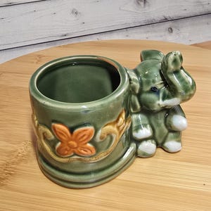 May include: A set of three ceramic mugs with a speckled, matte finish. The mugs are in shades of cream, light gray, and dark gray. Each mug has a simple, minimalist design, perfect for coffee or tea.