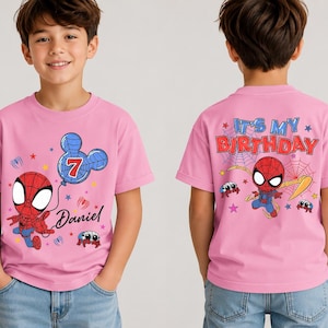 May include: A light pink short-sleeve t-shirt featuring a cartoon Spider-Man graphic. The front displays the name Daniel, a number 7 inside a blue Mickey Mouse-shaped balloon, and small spiders. The back features the text IT'S MY BIRTHDAY.