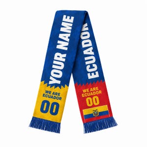 May include: A blue, yellow, and red scarf featuring the text YOUR NAME and ECUADOR in white. The scarf includes the phrase WE ARE ECUADOR, the number 00, and the national flag of Ecuador, finished with blue fringe at both ends of the fabric.